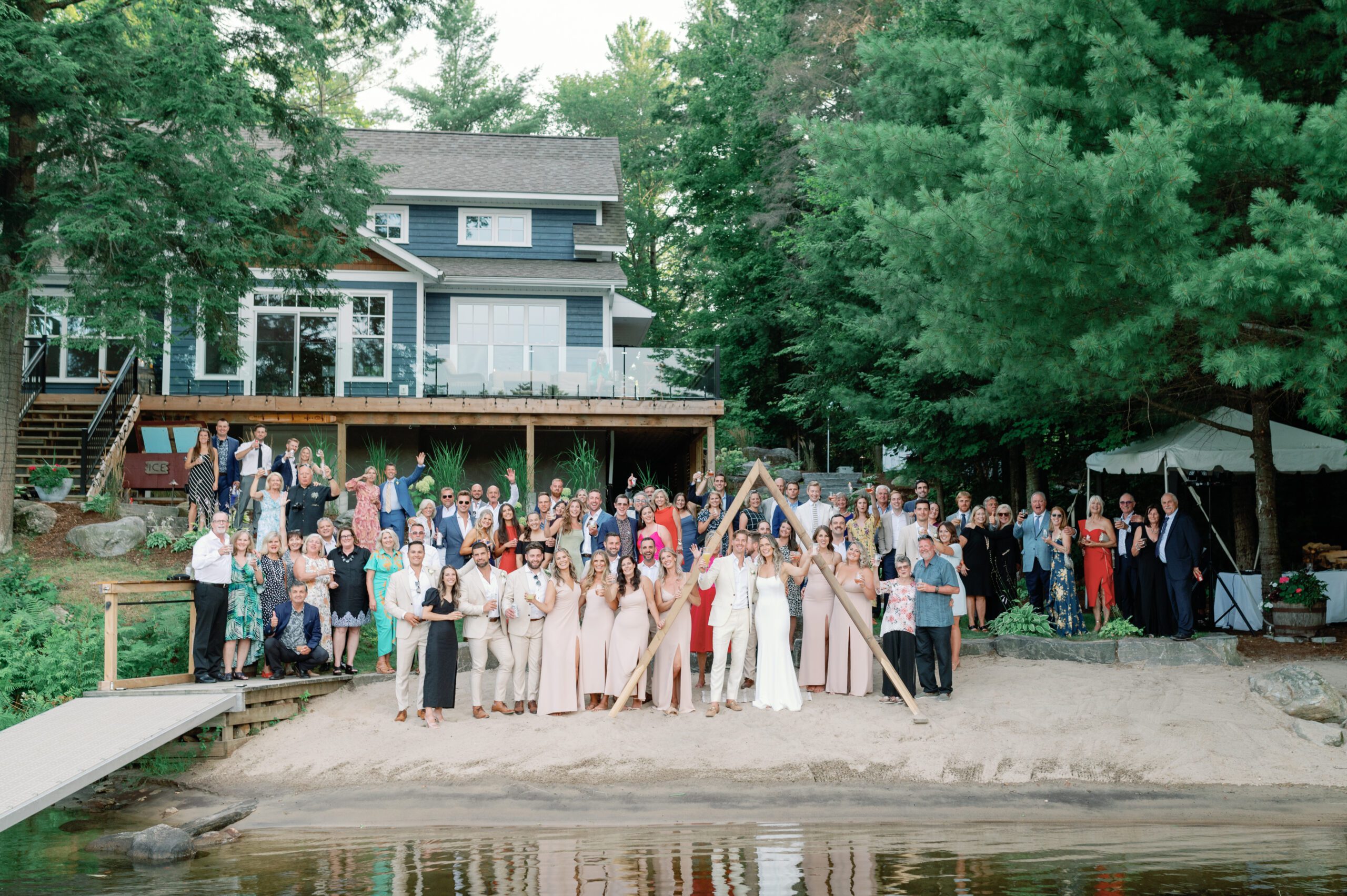 Group portrait of wedding guests at backyard wedding on Muskoka Lake.