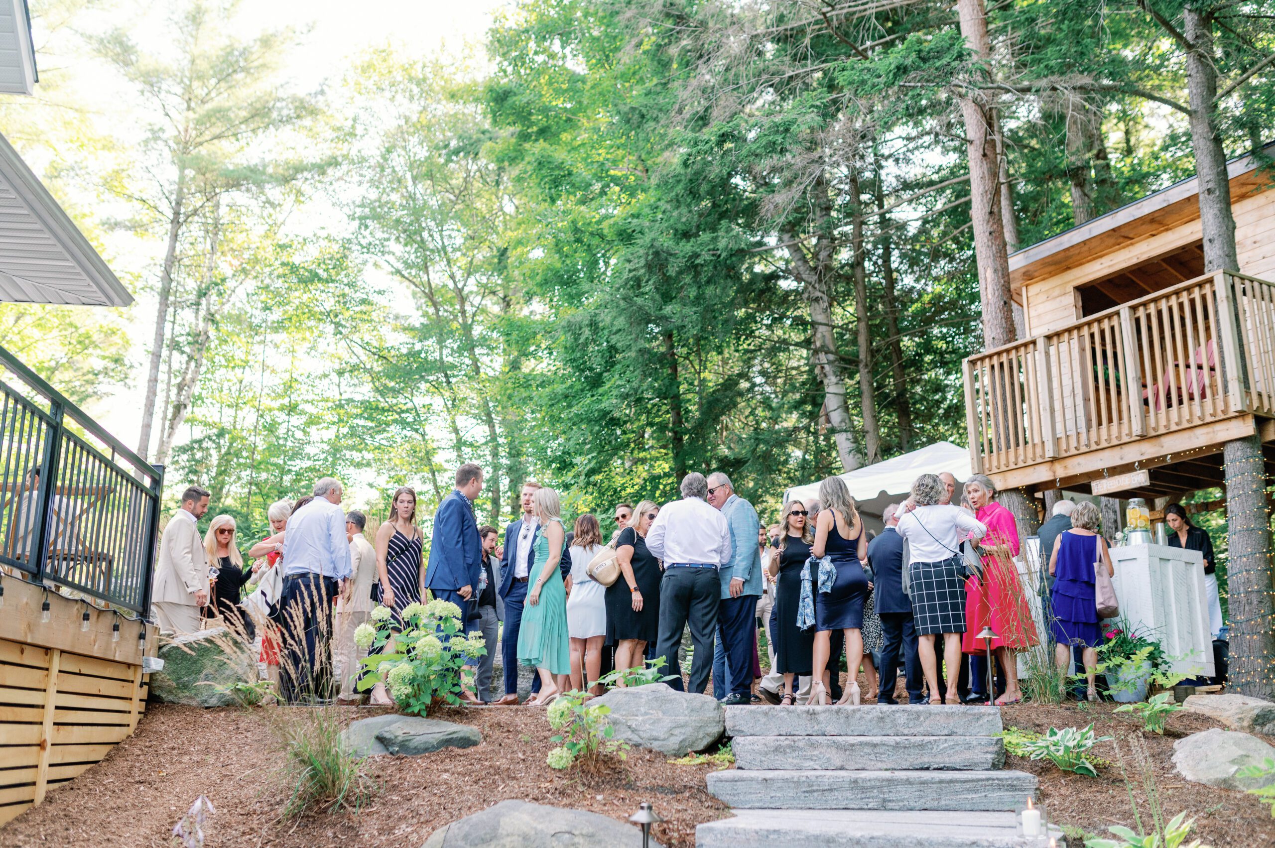 Guests being social at outdoor cottage wedding.