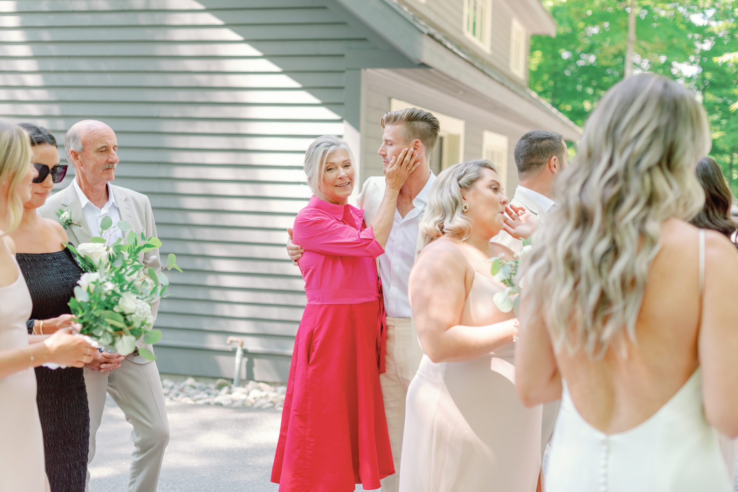 Cute moment between groom and mother at backyard wedding.