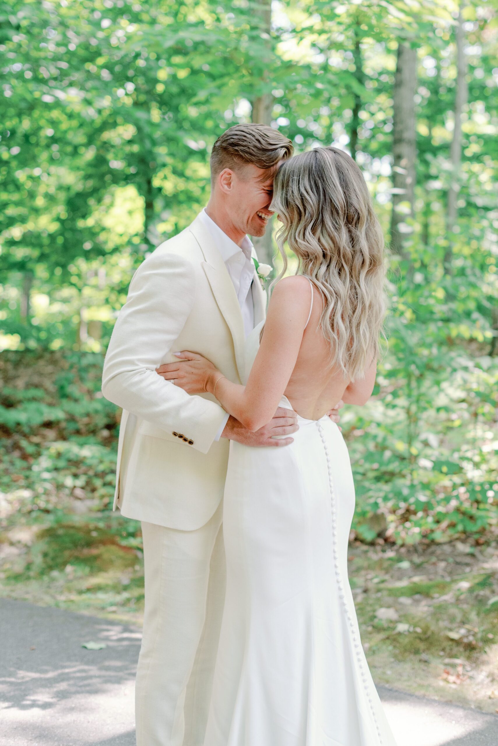 Intimate moment between bride and groom at outdoor wedding.