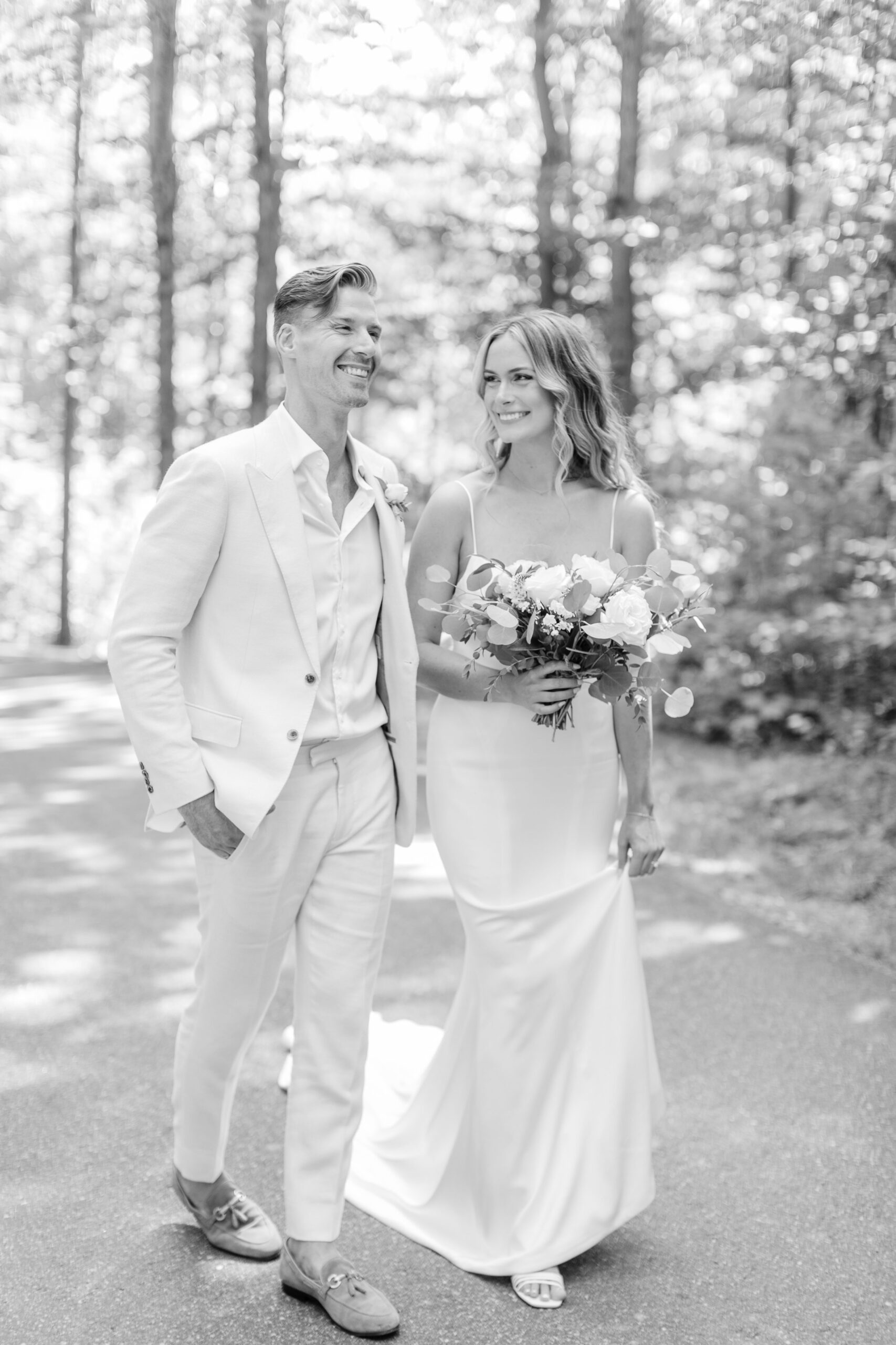 Candid moment of bride and groom smiling at each other at Muskoka wedding.