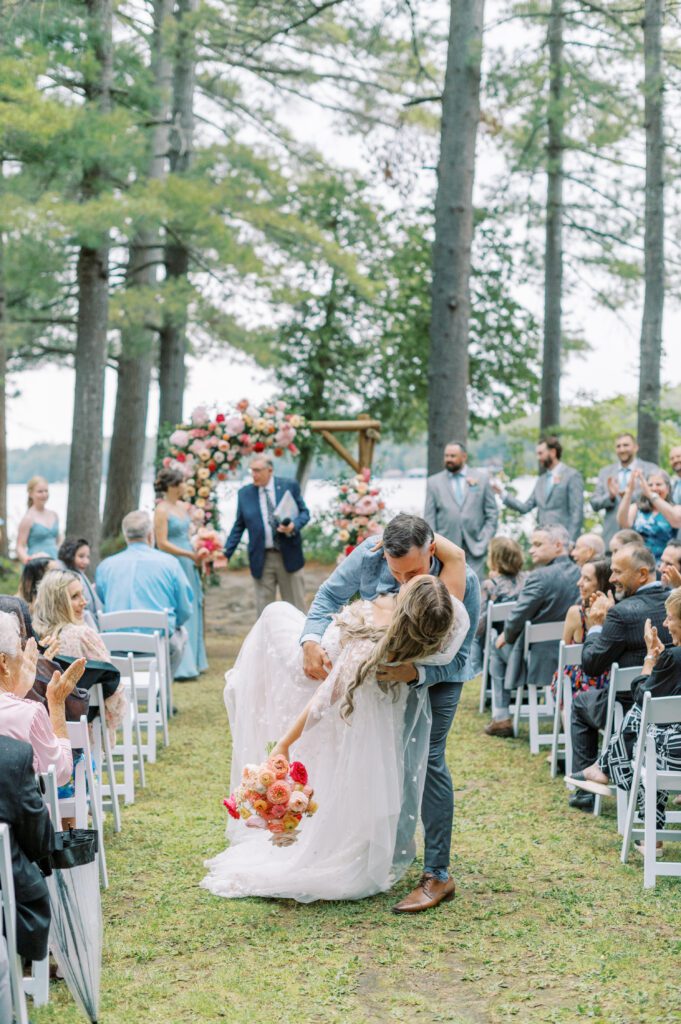 Muskoka wedding ceremony kiss dip.
