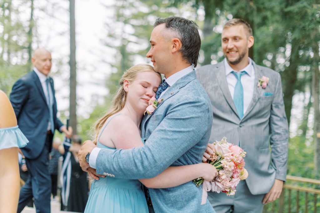 Emotional hug at Sherwood Inn after wedding ceremony.