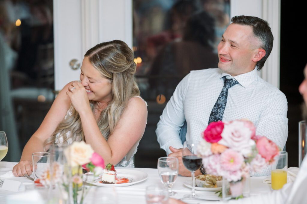 laughing bride and groom at their wedding reception in Muskoka.